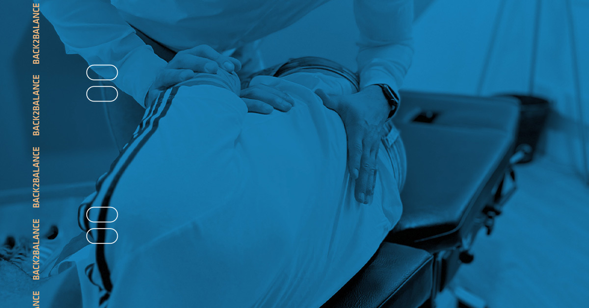 Chiropractor giving a lumbar spine manual adjustment to a patient with low back pain.