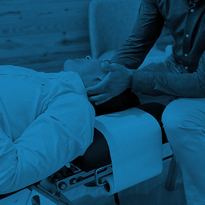 Patient on chiropractic table getting the neck adjusted by a chiropractor