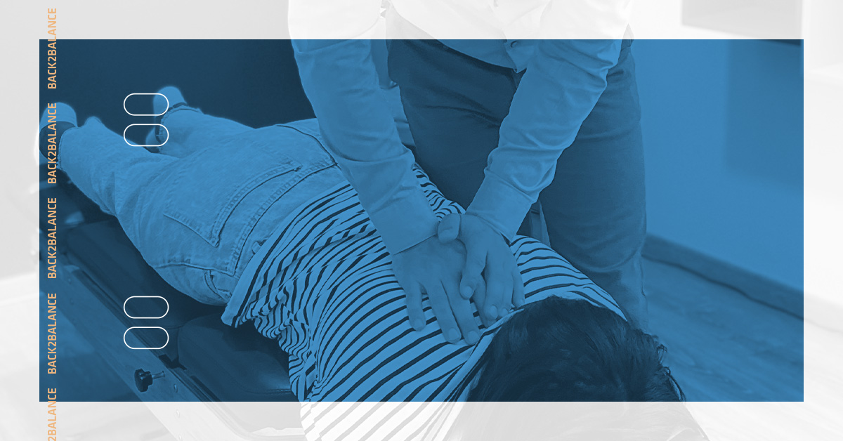 Chiropractic patient on table getting back checked by chiropractor.